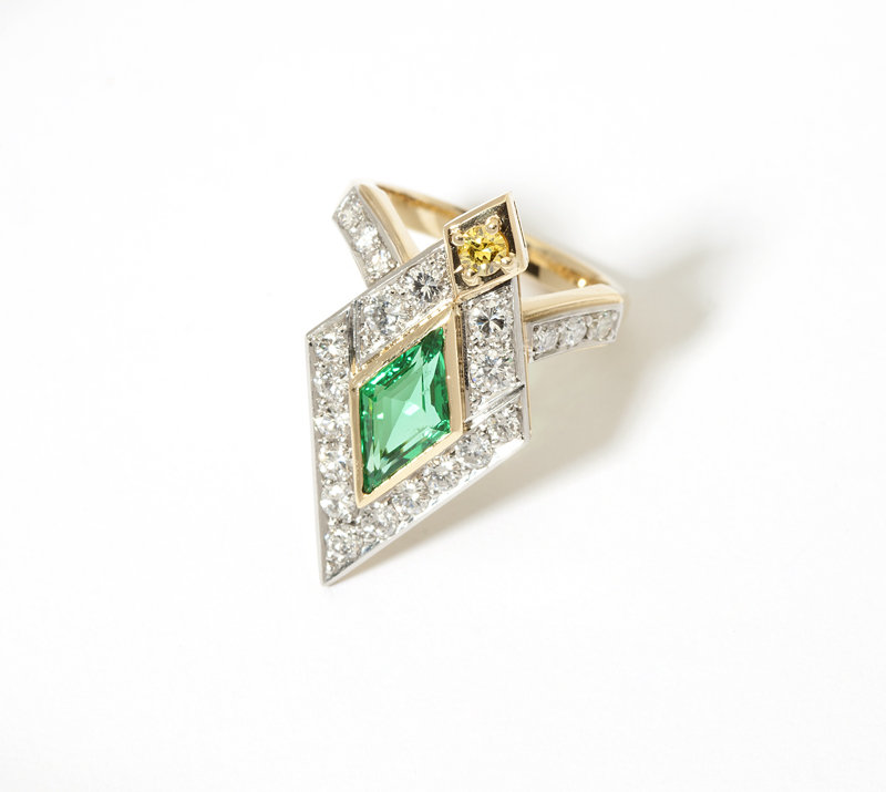 An emerald diamond and gold ring