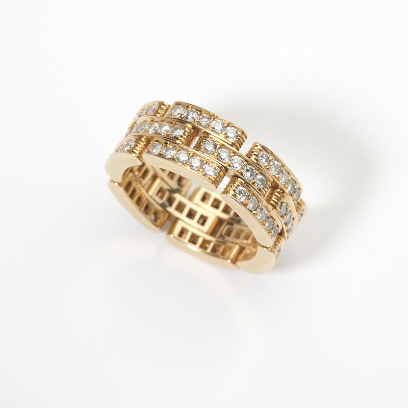A diamond and gold band Cartier