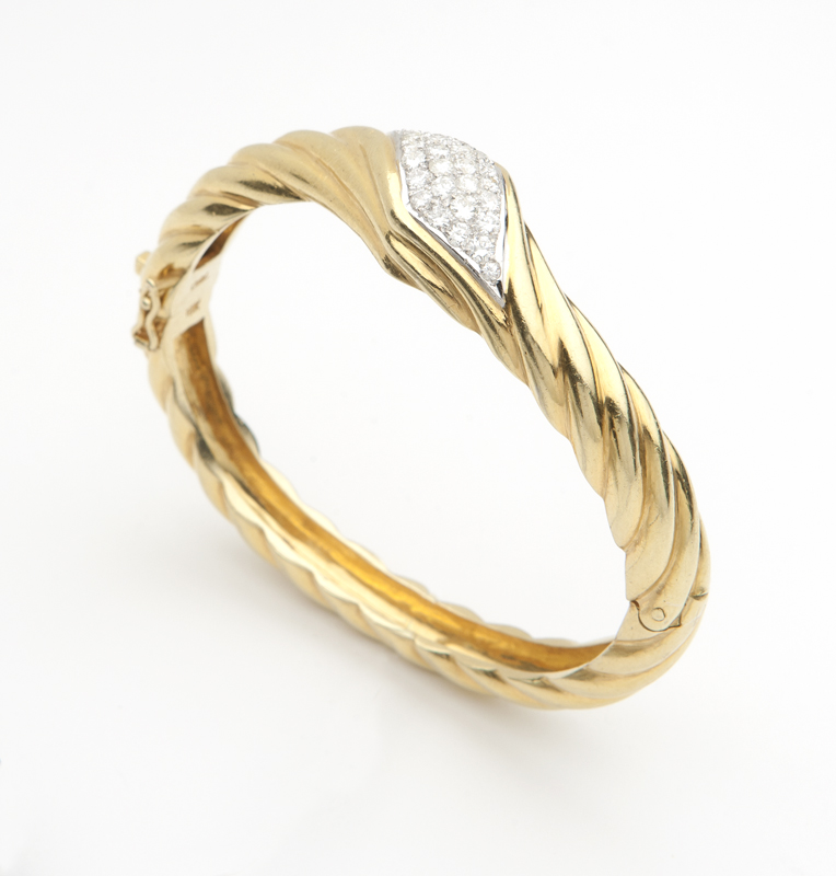 A diamond and gold rope bangle Stamped