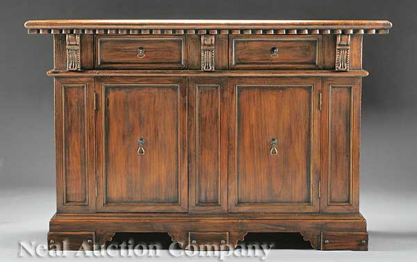 A Carved Walnut Credenza of Italian