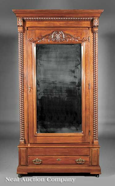An American Carved Walnut Armoire