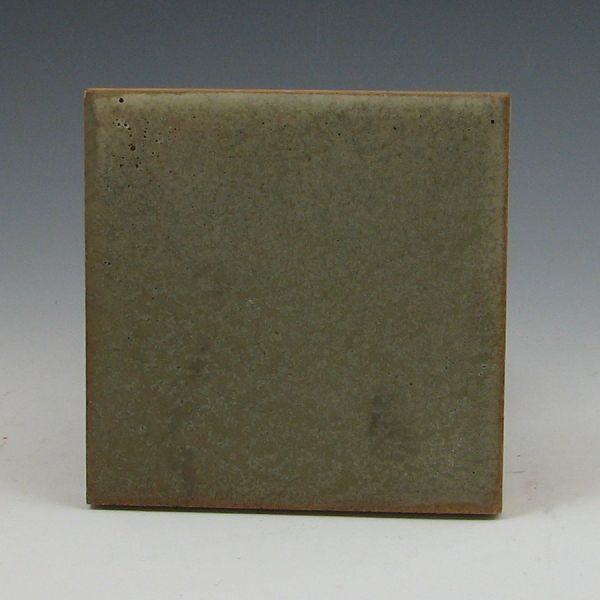 Rookwood tile with matte green glaze.