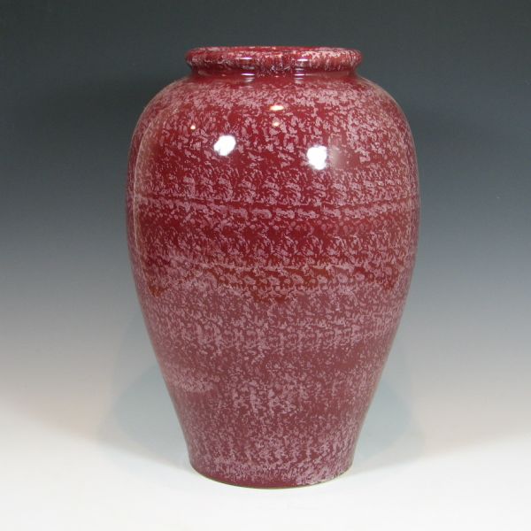 McCoy oil jar in speckled white on maroon.