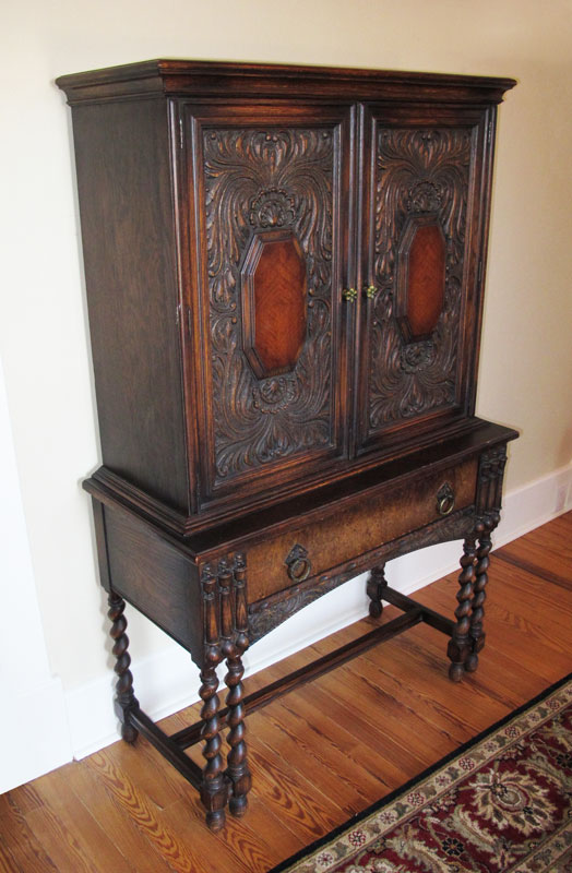 1930'S CARVED OAK BLIND CUPBOARD: