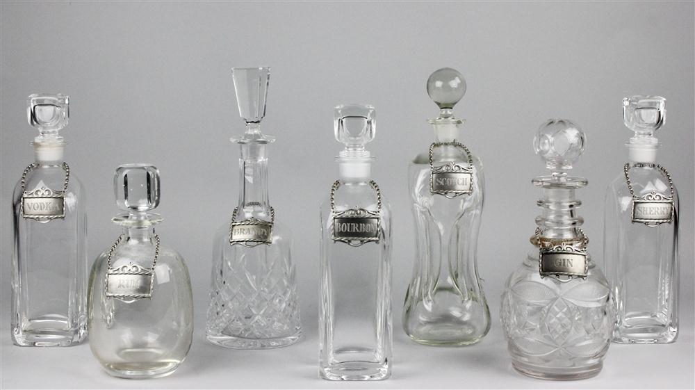 SEVEN GLASS DECANTERS AND STOPPERS