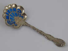 A silver and enamel caddy spoon by Gorham