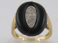An 18 carat gold onyx and diamond ring.
