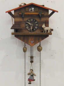 A Swiss cuckoo clock with girl on swing