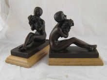 A pair of bronze bookends modelled 14abcd