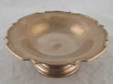 A silver tazza with shaped rim