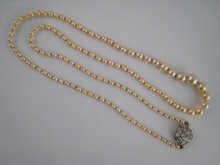 A graduated natural pearl necklace