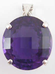 A faceted amethyst pendant set in white