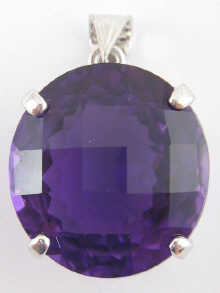 A faceted amethyst pendant set