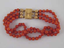A three strand coral beaded bracelet