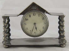 A plated mantel clock the dial beneath