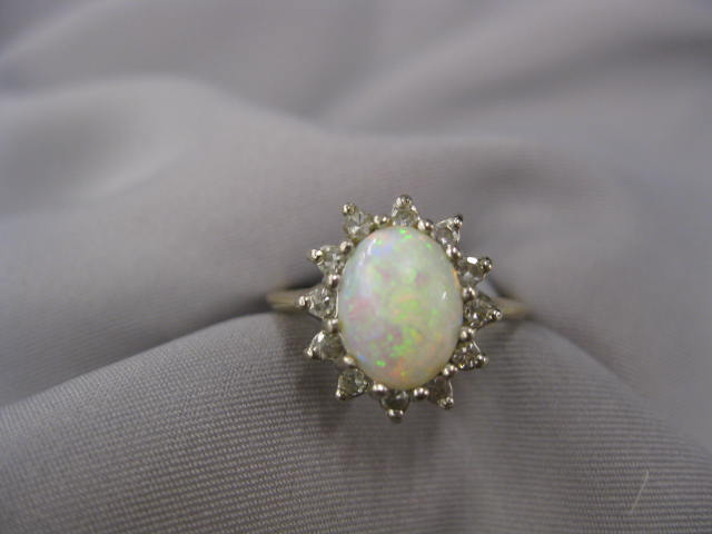Opal & DIamond Ring fiery gem surroundedby