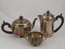 A three piece silver tea set of pot