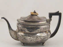 A barge shaped silver teapot with decorated