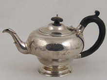 A silver tea pot on single foot hallmarked