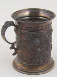 A silver christening mug decorated