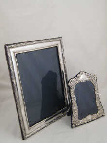 A silver photo frame with ribbon and