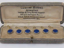A boxed set of six blue enamel buttons