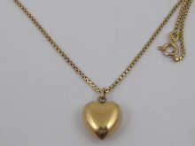 A yellow metal (tests 9 ct gold) heart