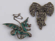 A silver and marcasite clip together