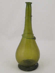 A green glass flask with trailed