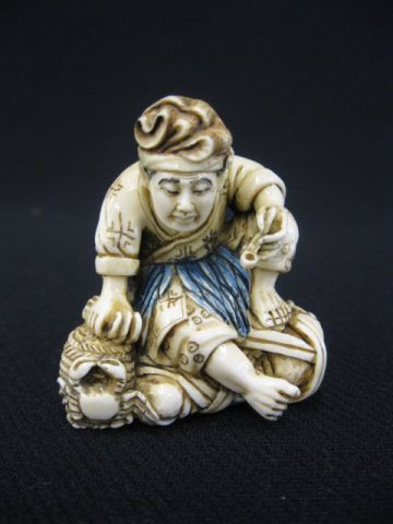 Carved Ivory Netsuke of a Man with 14c064