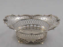 A small pierced silver basket with applied