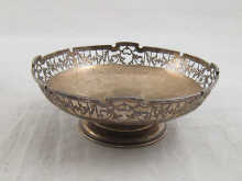 A siilver bowl on foot with pierced