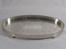 A silver oval tray on four feet