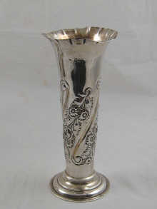 An embossed silver vase with crimped