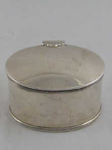 An oval silver tea caddy the lid