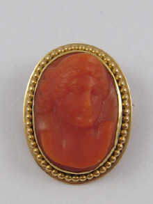 A carved coral cameo mounted as
