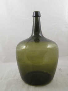 A large green glass demijohn probably