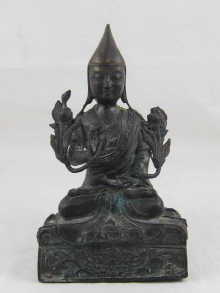 A bronze Hindu deity in the lotus position