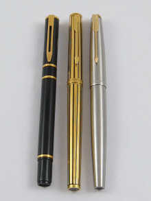 Two Parker pens and a Waterman pen.