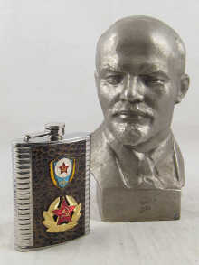 A metal bust of Lenin measuring