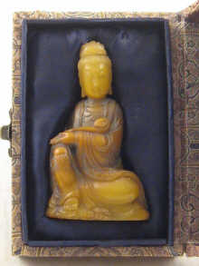 A carved soapstone figure of Guanyin