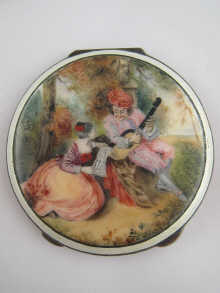 A silver compact decorated with a romantic