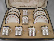 A cased porcelain and silver tea set