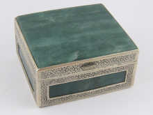 A white metal box set with green hard