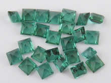 A quantity of loose polished green