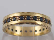 A 9 carat gold sapphire set eternity