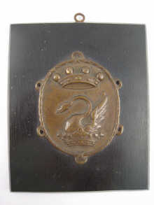 An oval bronze plaque cast in relief