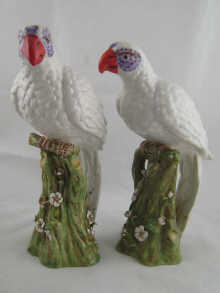 A pair of ceramic white parrots each