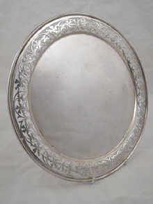 A circular silver salver with pierced 149d35