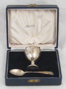 A boxed silver egg cup and spoon by
